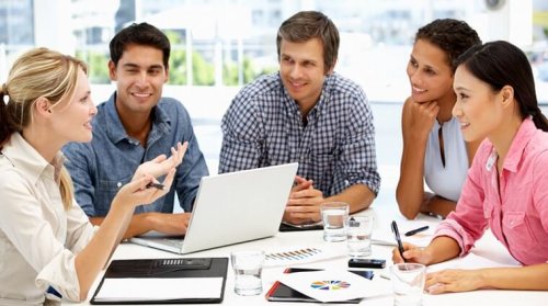 Five people discussing ideas at work.