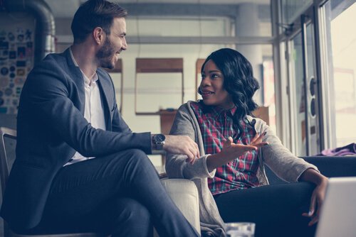 Two co-workers maintaining eye contact while talking.