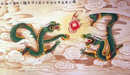 Two green dragons breathing fire.