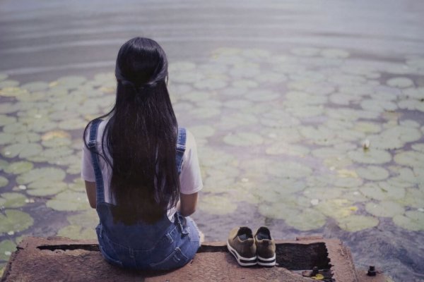 The girl with bracelets on the wharf with feeling of shame.