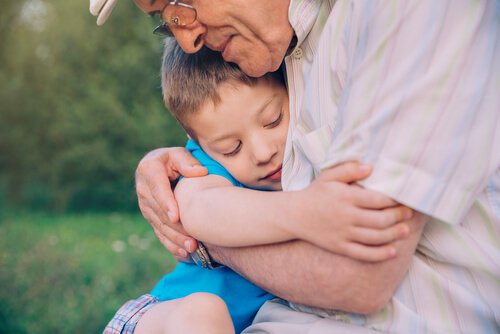 A grandpa hugging his grandson.
