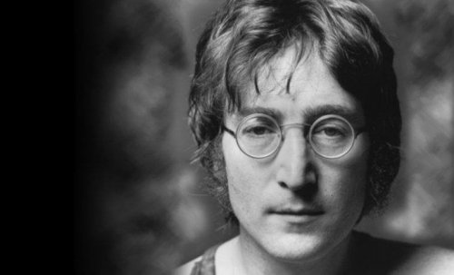 Black and white portrait of John Lennon.