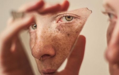Man looking into a piece of glass.