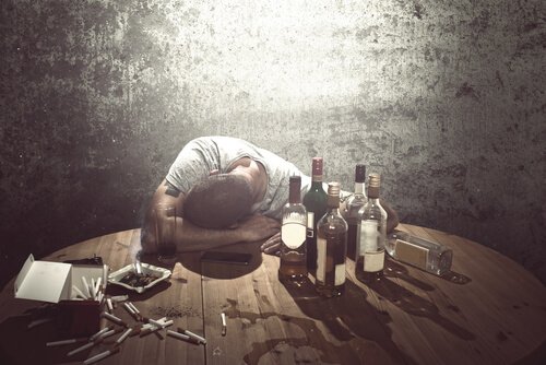 A man surrounded by bottles of alcohol.