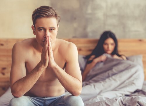 Man with performance anxiety in bed thinking about his sexual dysfunction.