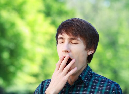 A man yawning because he is bored.