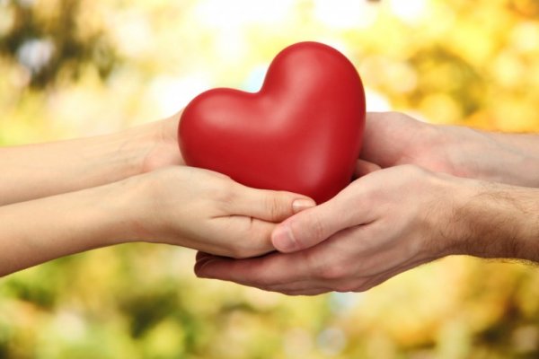 Clay person giving their heart away.