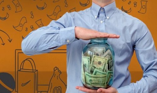 S man holding a jar full of money.