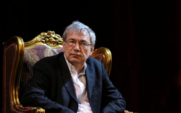 Orhan Pamuk sitting down reflecting on his works.