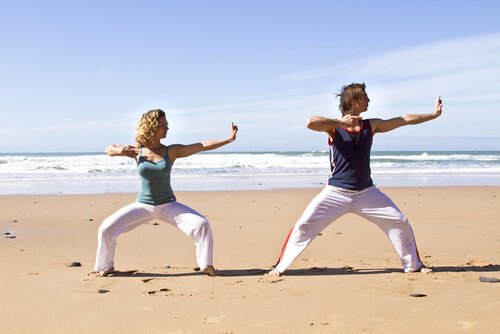 People doing qigong on the beach.