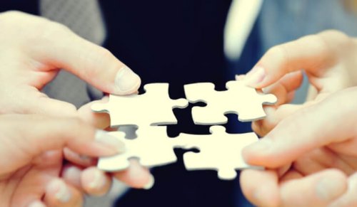 People putting puzzle pieces together.