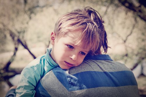 Sad boy with low self-esteem hugging his brother.