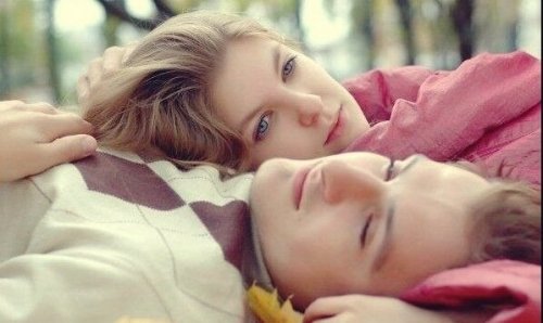 Couple laying on the ground.