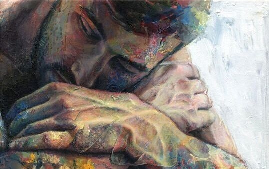 Sad guy without the love he deserves sleeping with head in arms.