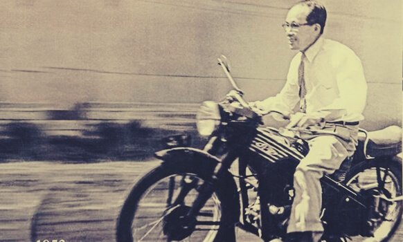 Soichiro Honda riding a motorcycle.