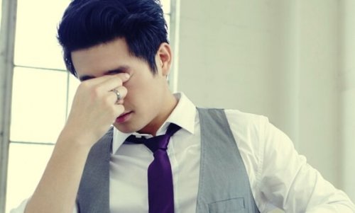 Anxious man with his hand on his face.