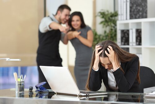 Toxic coworkers making fun of a woman.