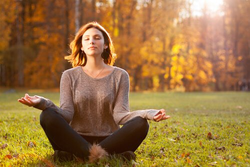 woman meditating in a field