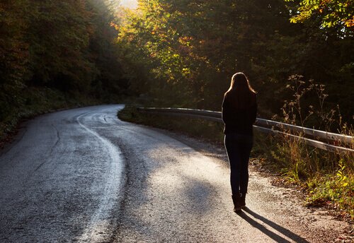 Woman walking alone on the road.