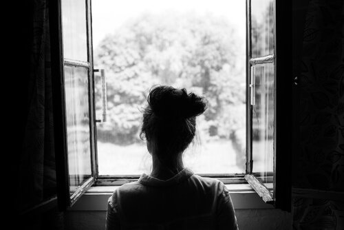 A woman looking out a window.