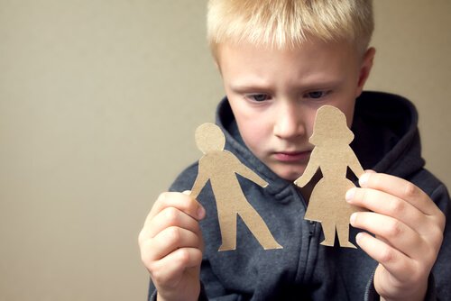 Boy looking at mom and dad cardboard figures.
