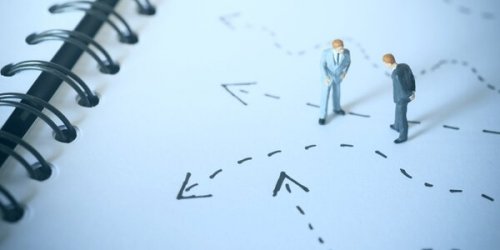 Two figures looking at the floor deciding where to go.