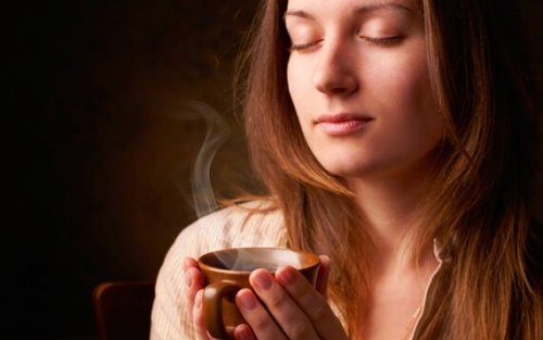 Woman smelling coffee.
