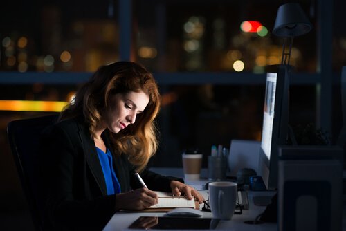 Workaholic woman working late in the office.
