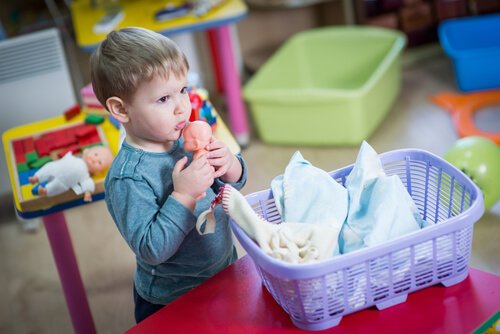 A transsexual boy playing with doll.