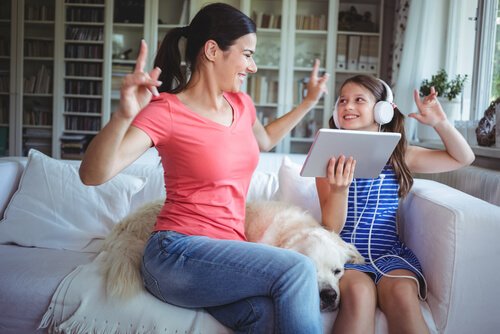 A mother and daughter laughing and singing together.