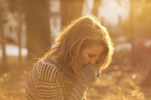 Sad woman in forest.