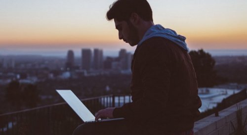 Boy using a computer, working on his professional career.
