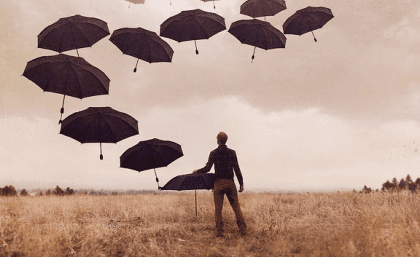 Boy with umbrellas and with depression.