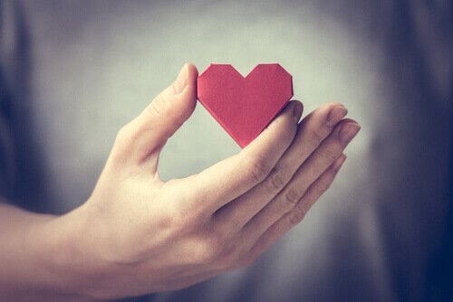 A hand holding a heart.