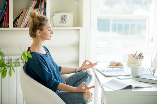 Woman practicing simple meditation exercises with her eyes closed.