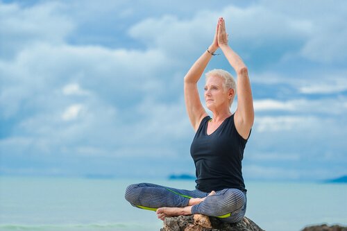 An old woman doing yoga.
