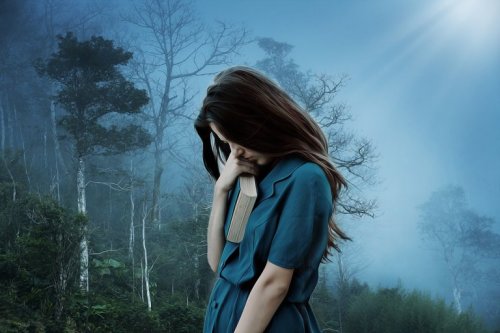 A woman with depression in the forest.