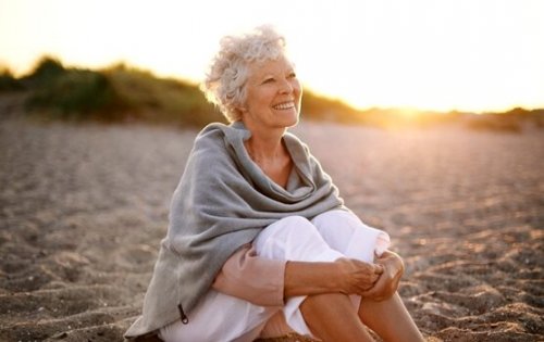 Happy senior woman on the beach.