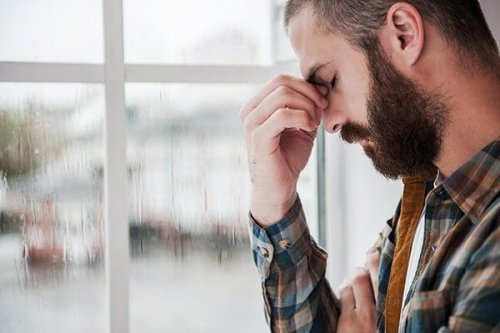 A guy experiencing depression, one of the hidden causes of laziness.