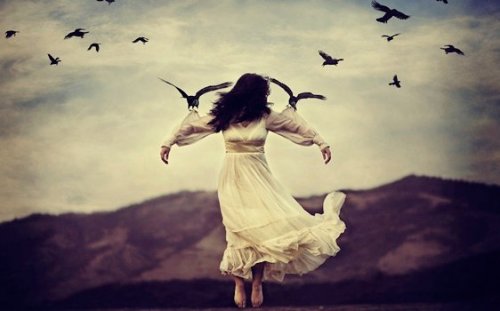 A woman being held up by birds.