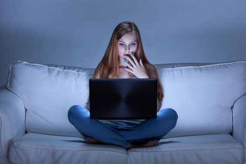 A woman watching movies for her mental health.