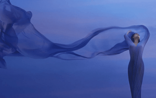 Woman with purple dress in the wind.