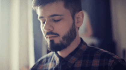 A boy with his eyes closed.