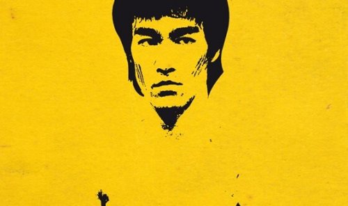 Painting of Bruce Lee on a yellow wall.
