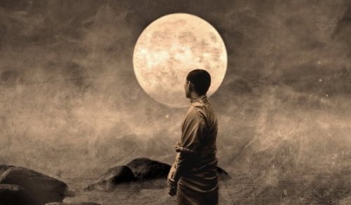 Buddhist monk in front of the moon.