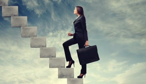 A business woman with ambition climbing stairs.
