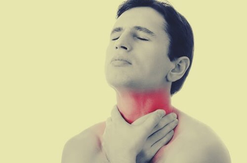 A man touching his painful throat.