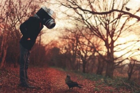 Man with a camera head.