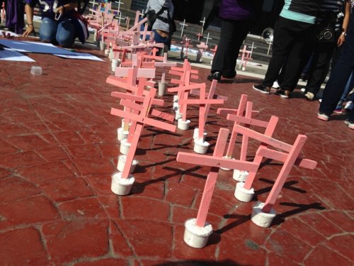 Pink crosses on the street representing femicides.