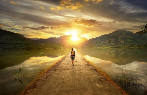 Woman walking towards the mountains.